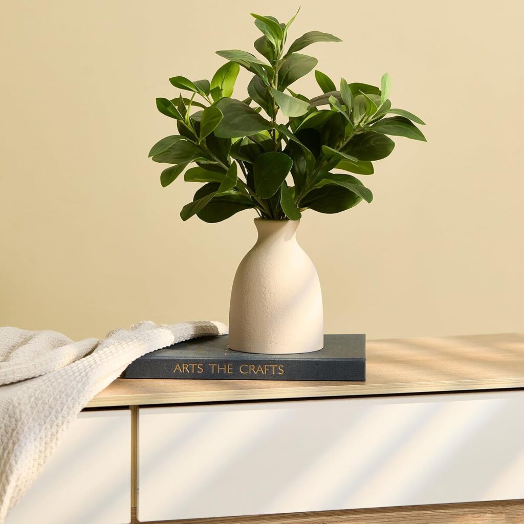 Eucalyptus in Ceramic Vase in a white vase on a table top