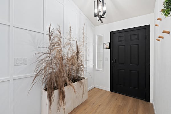 artificial plant design in front of the entrance door