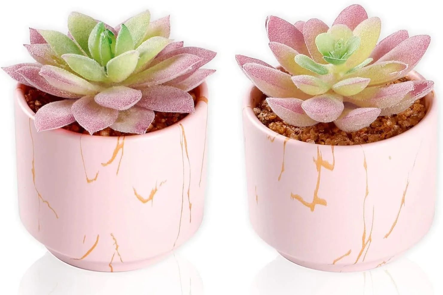 Set of two mini artificial succulents in blush pink ceramic pots on a clean surface