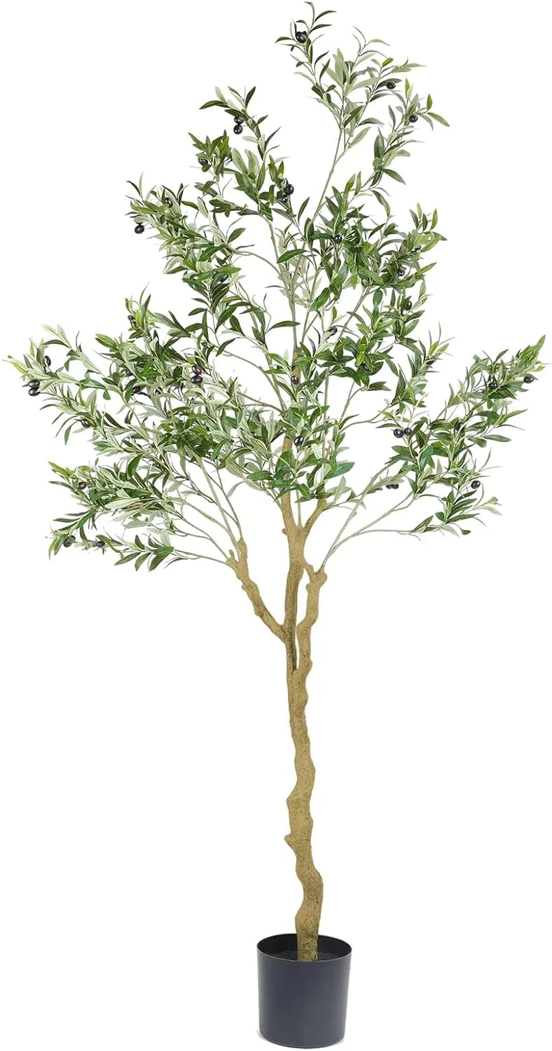 Tall artificial olive tree with large fruits next to a desk in a modern office
