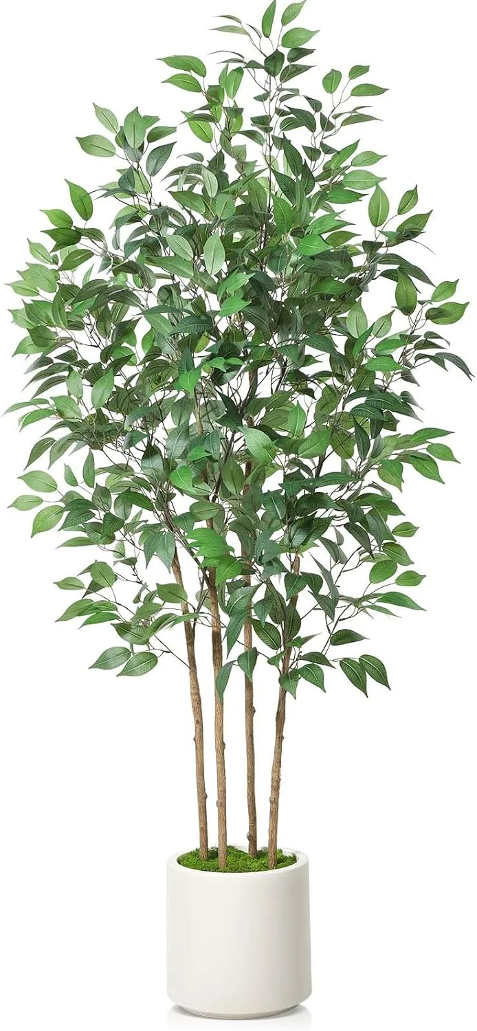 Tall artificial ficus tree in a white planter placed in a home office corner