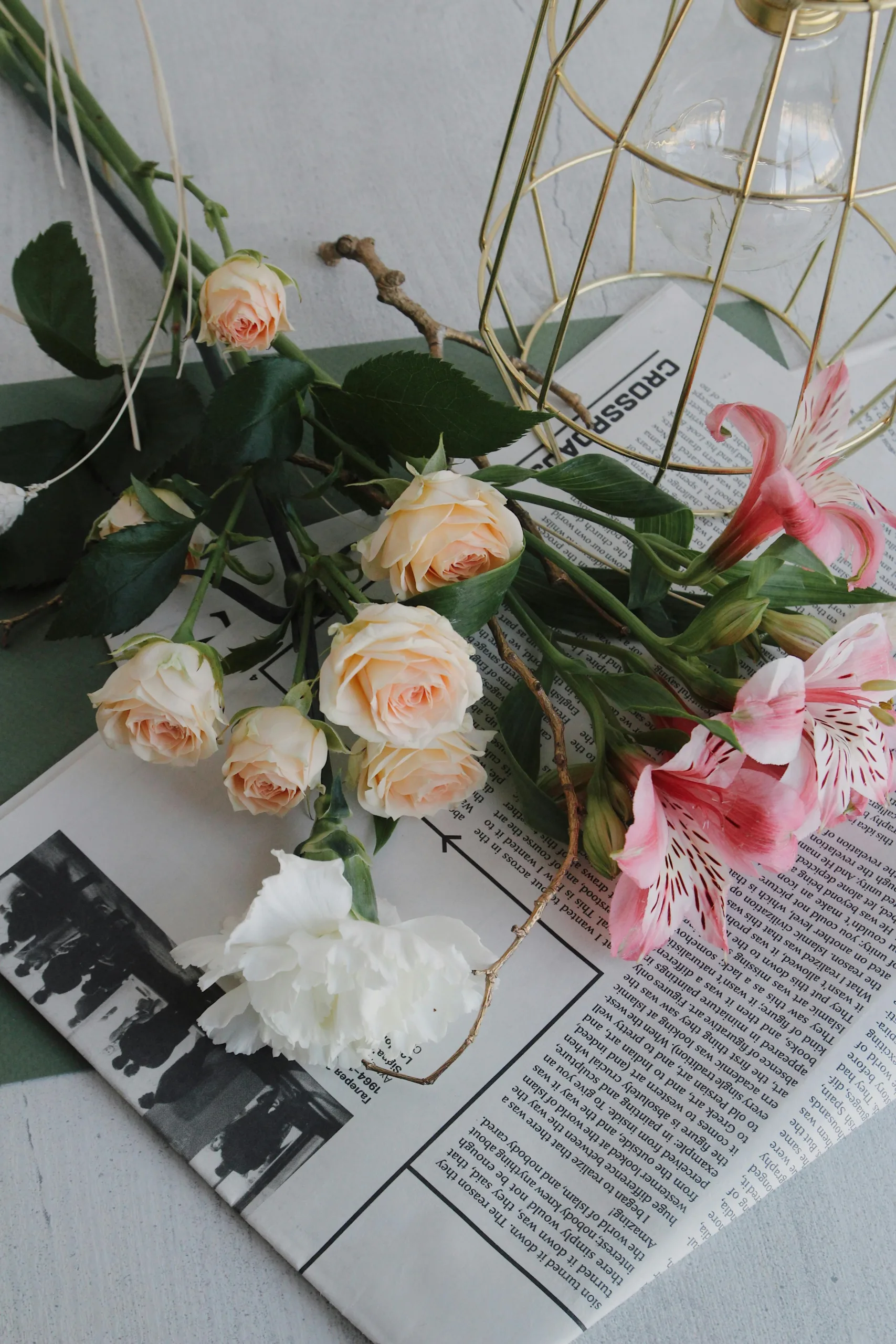 Beautiful mixed color roses aesthetically prepared on top of newspaper