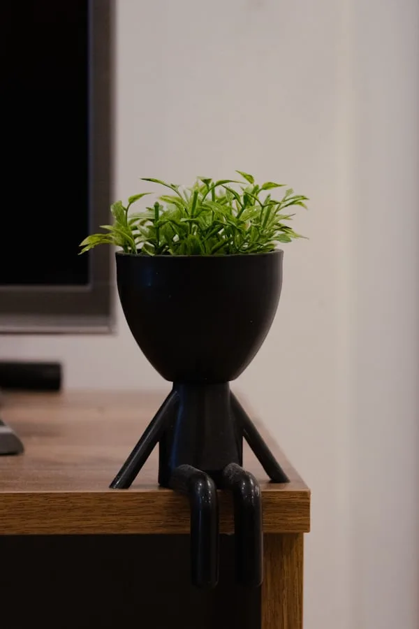 Stick figure artificial plant placed at the corner of the desk